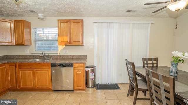 kitchen with dishwasher, sink, light tile patterned floors, and ceiling fan