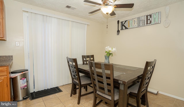 dining space featuring ceiling fan, a textured ceiling, and light tile patterned floors