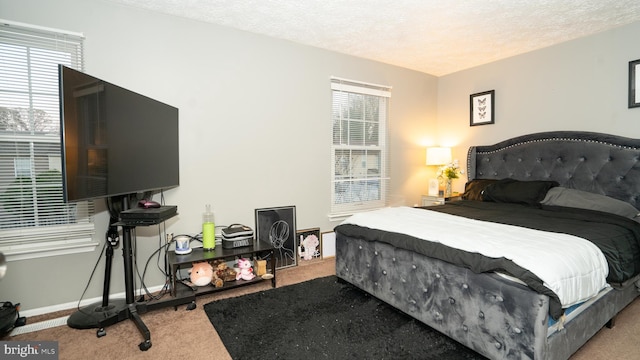 carpeted bedroom featuring a textured ceiling