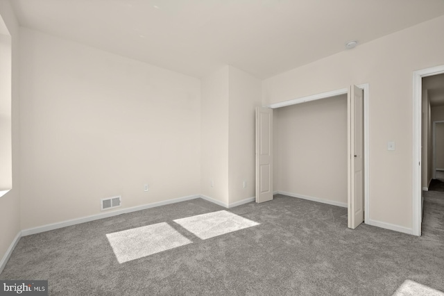 unfurnished bedroom featuring carpet flooring, baseboards, and visible vents