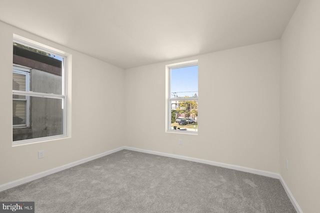 empty room featuring light colored carpet