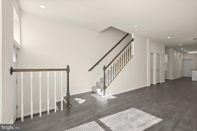 staircase with hardwood / wood-style floors