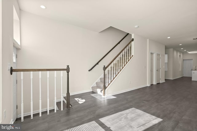 stairway with baseboards, recessed lighting, and wood finished floors
