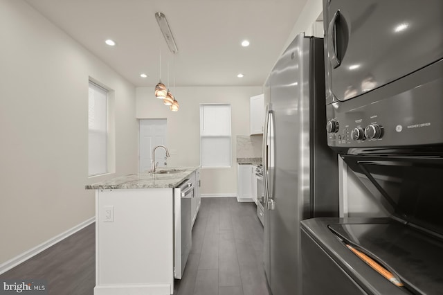 kitchen with sink, white cabinetry, decorative light fixtures, dark hardwood / wood-style floors, and a kitchen island with sink