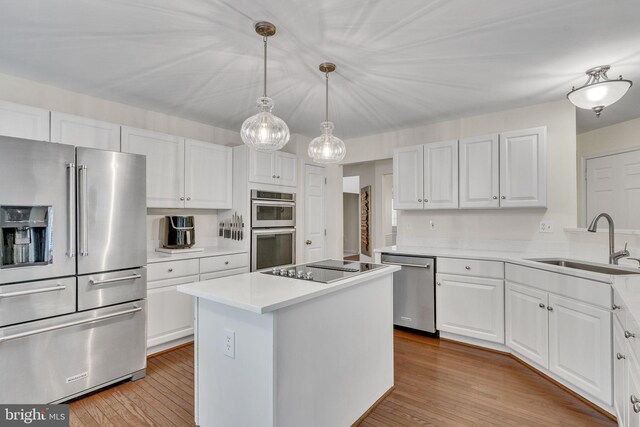 kitchen with white cabinetry, appliances with stainless steel finishes, and sink