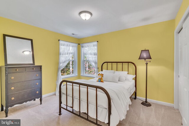 carpeted bedroom with a closet