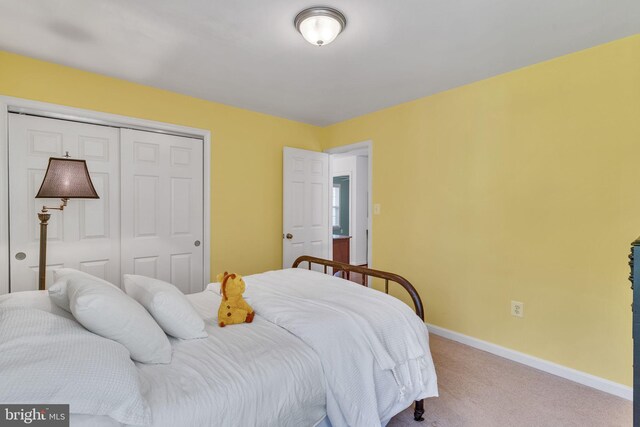 carpeted bedroom featuring a closet