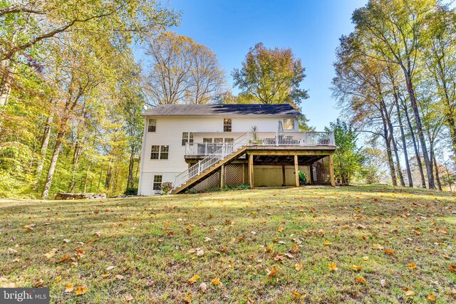 back of house with a wooden deck and a yard