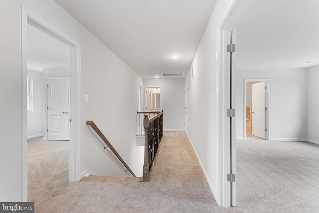 hall with light colored carpet