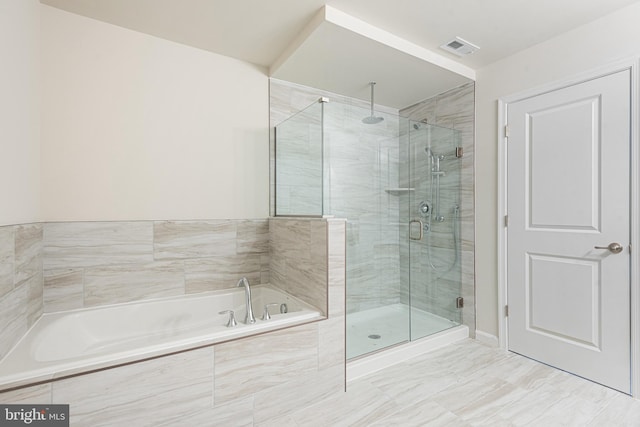 bathroom with shower with separate bathtub