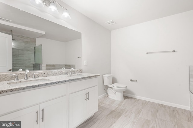 bathroom with vanity, toilet, and an enclosed shower