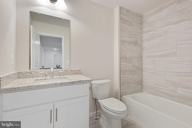 full bathroom with vanity, toilet, wood-type flooring, and tiled shower / bath