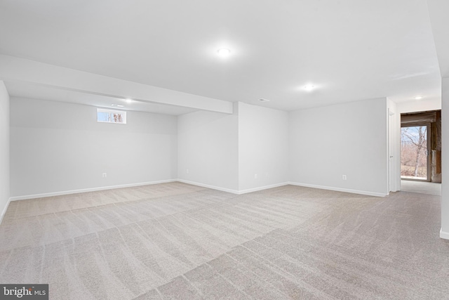 spare room featuring light colored carpet