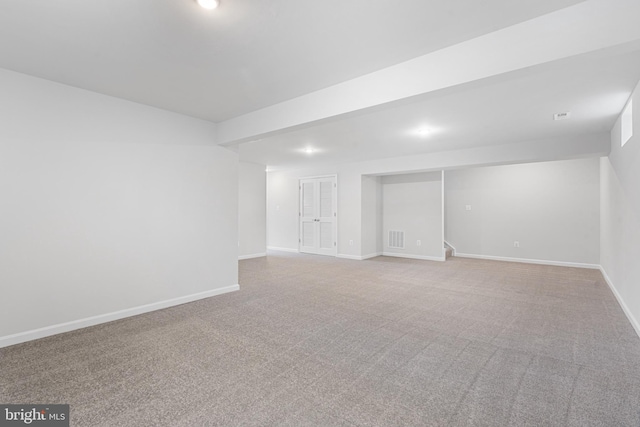 basement featuring light colored carpet