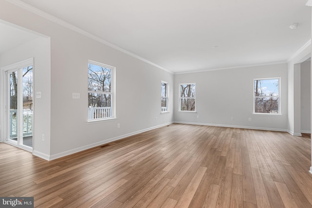 unfurnished living room with ornamental molding, light hardwood / wood-style flooring, and plenty of natural light