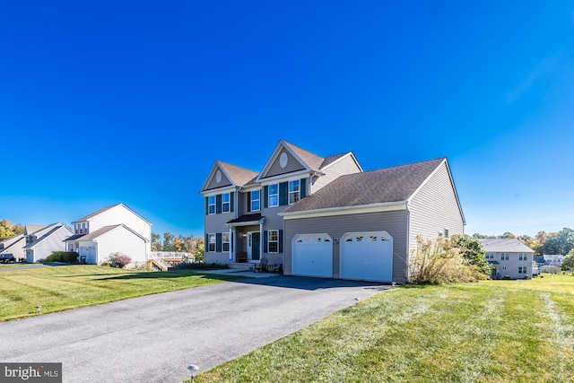 view of front facade featuring a front lawn and a garage