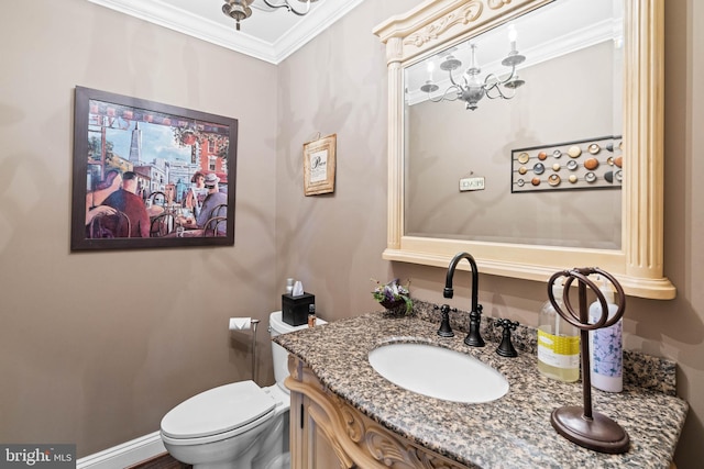 bathroom with vanity, toilet, and crown molding