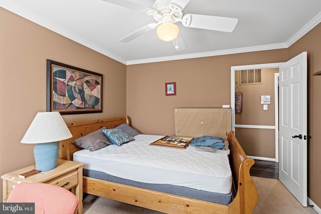 bedroom with carpet flooring, ceiling fan, and ornamental molding