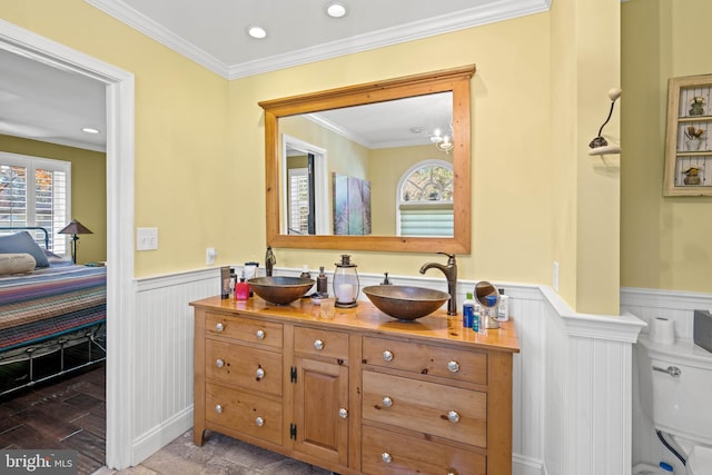 bathroom featuring toilet, vanity, ornamental molding, and hardwood / wood-style flooring