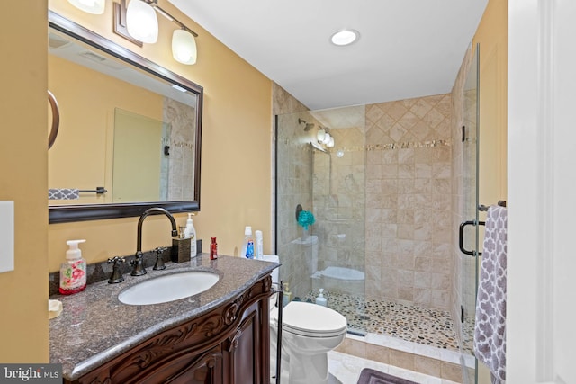 bathroom with tile patterned floors, vanity, toilet, and an enclosed shower