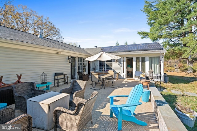 rear view of house featuring solar panels