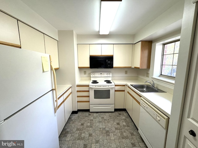 kitchen featuring sink and white appliances