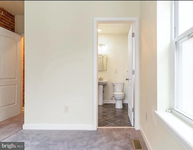 bathroom featuring toilet and tile patterned flooring