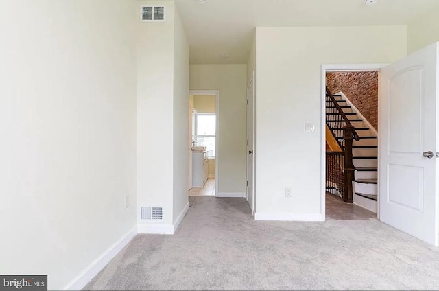 interior space featuring light carpet