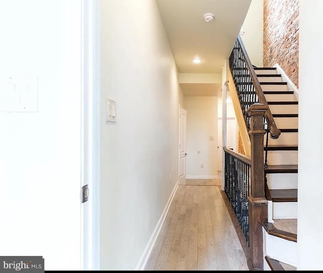 staircase with hardwood / wood-style floors