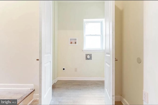 clothes washing area with light hardwood / wood-style floors, hookup for an electric dryer, and washer hookup