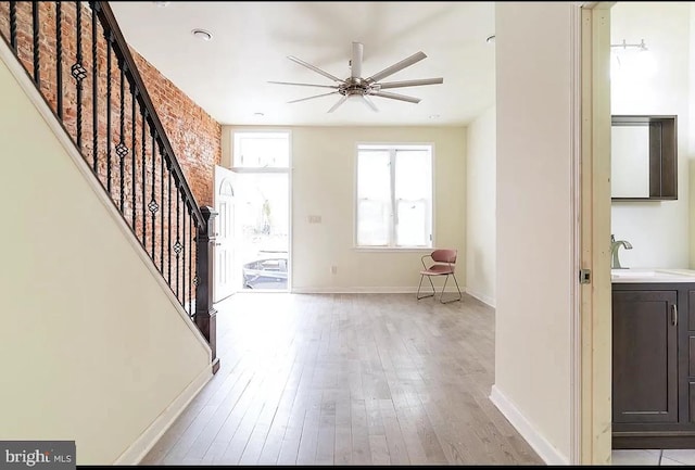 foyer entrance with sink and light hardwood / wood-style flooring