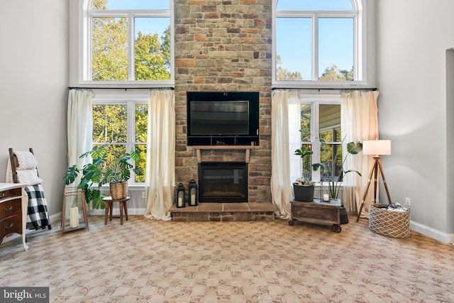 unfurnished living room with light colored carpet and a fireplace