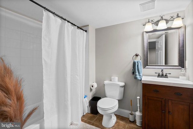 bathroom with vanity, toilet, and tile patterned flooring