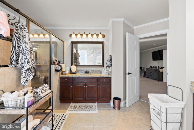 bathroom with vanity, crown molding, and tile patterned flooring