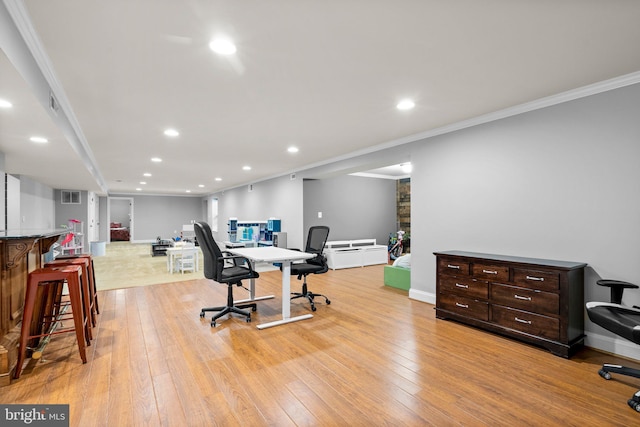 office with ornamental molding and light wood-type flooring