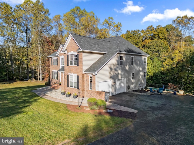 view of front facade with a front yard and a garage