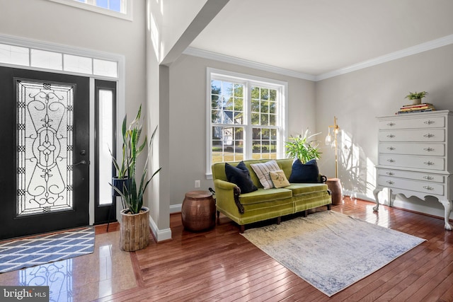 foyer entrance with hardwood / wood-style floors and crown molding