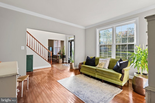 living room featuring hardwood / wood-style flooring and ornamental molding