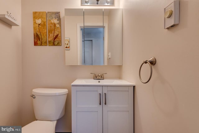 bathroom featuring toilet and vanity