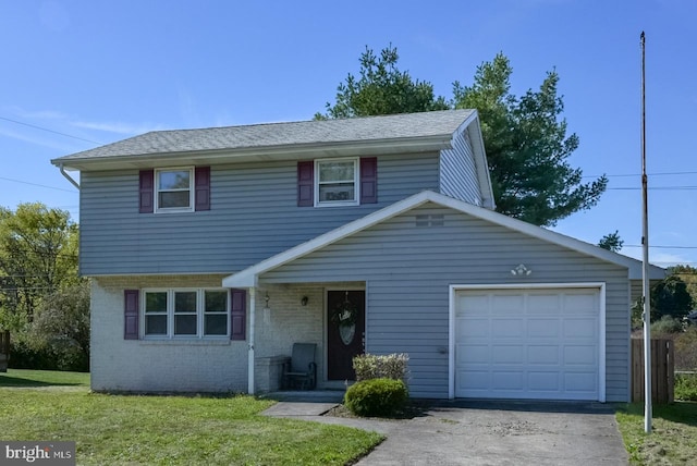 view of front property featuring a front yard and a garage