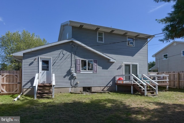 rear view of property featuring a lawn