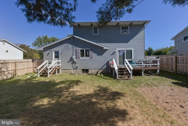 back of house with a wooden deck and a yard