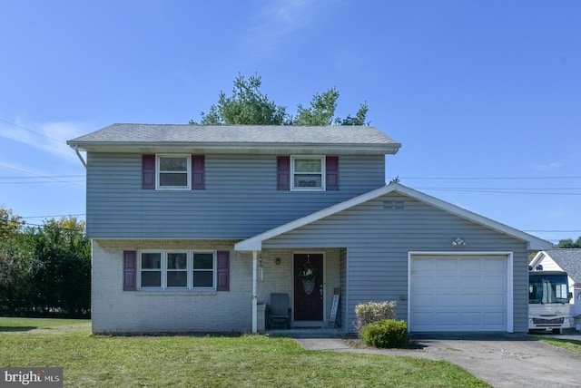 front of property with a front yard and a garage