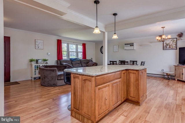 kitchen featuring light hardwood / wood-style flooring, ornamental molding, and a center island