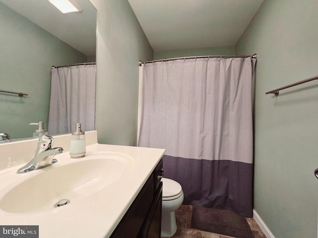 bathroom featuring toilet, vanity, a shower with shower curtain, and tile patterned flooring