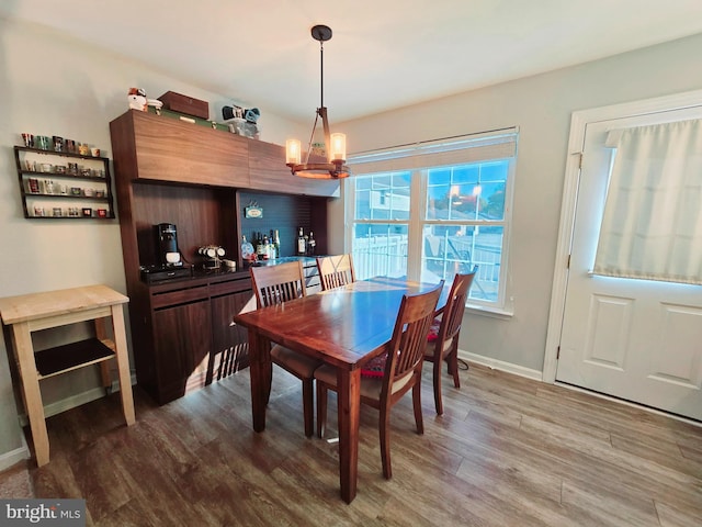 dining space featuring a chandelier and wood-type flooring