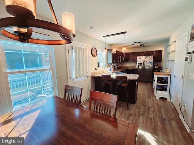 dining area featuring dark hardwood / wood-style floors and sink