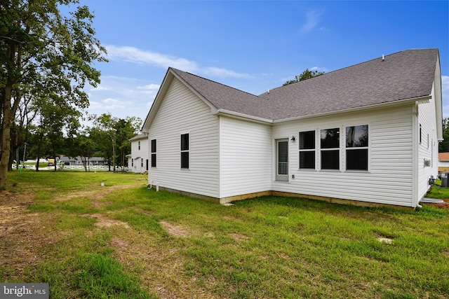 view of property exterior with a lawn