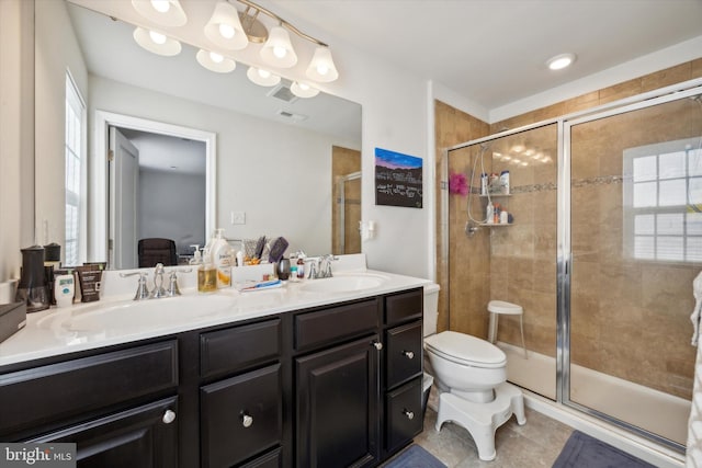 bathroom with vanity, toilet, tile patterned floors, and a shower with shower door