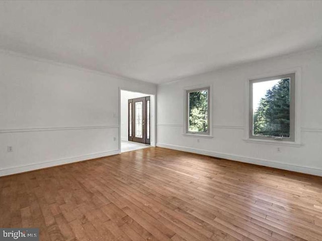 empty room with light hardwood / wood-style flooring